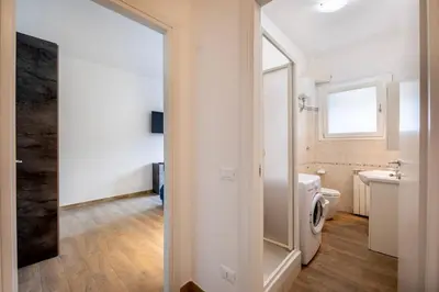a bathroom with a toilet and a sink and a mirror at CASA LINO in Rome