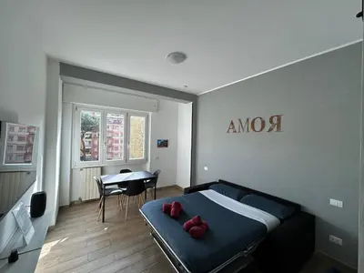 a bedroom with a bed with red pillows on it at CASA LINO in Rome