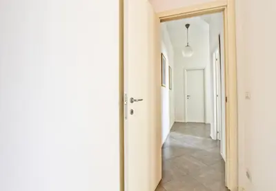 a hallway with white walls and a white hallway at [Roma centro Storico * * * * *]- Via Torino Suite in Rome