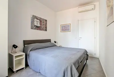 a bedroom with a bed and a small night stand at [Roma centro Storico * * * * *]- Via Torino Suite in Rome