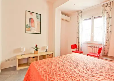 a bedroom with a bed and two red chairs at [Roma centro Storico * * * * *]- Via Torino Suite in Rome