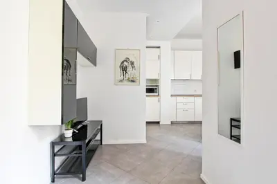 a kitchen with white walls and a black table at [Roma centro Storico * * * * *]- Via Torino Suite in Rome
