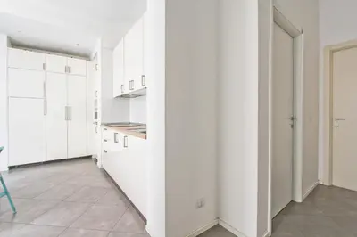 a kitchen with white cabinets and a tile floor at [Roma centro Storico * * * * *]- Via Torino Suite in Rome