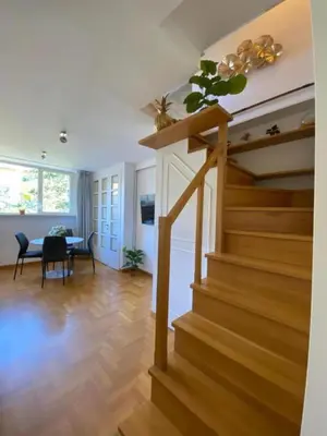 a staircase in a living room with a table at Margutta Domitia Home in Rome