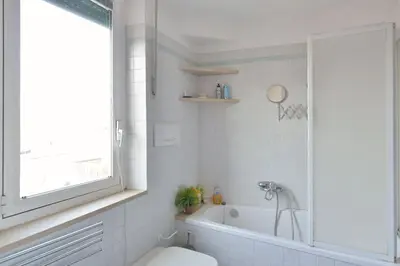 a bathroom with a tub and a toilet and a sink at SUPER SUNNY PENTHOUSE WITH TERRACE in Rome