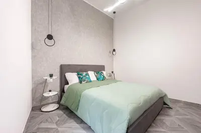 a bedroom with a large bed in a white room at Charming Apartment in the centre of Rome in Rome