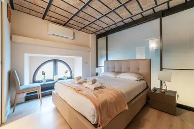 a bedroom with a large bed and a window at Luxury Loft next to Via Veneto in Rome