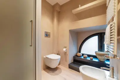 a bathroom with a toilet and a sink and a window at Luxury Loft next to Via Veneto in Rome
