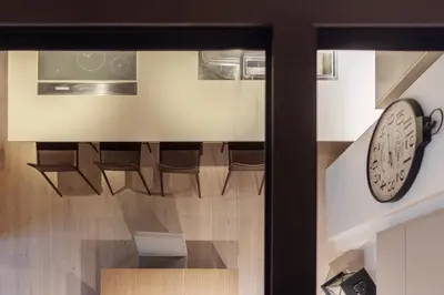 a room with chairs and a clock on the wall at Luxury Loft next to Via Veneto in Rome
