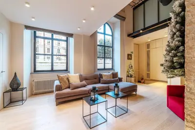 a living room with a couch and a table at Luxury Loft next to Via Veneto in Rome