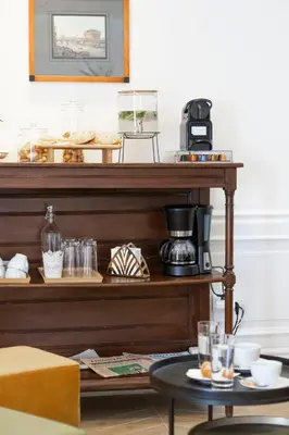 a shelf with a coffee maker and glasses on it at Domus Vitra in Rome