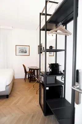 a living room with a black book shelf at Domus Vitra in Rome