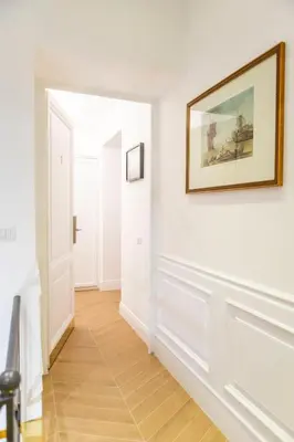 a hallway with white walls and a picture on the wall at Domus Vitra in Rome