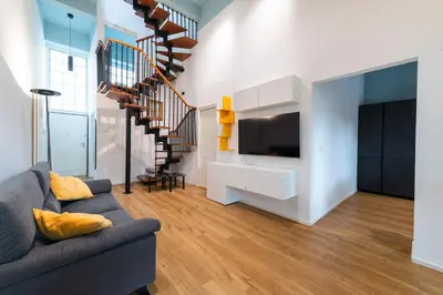a living room with a couch and a tv at Loft Porta Maggiore in Rome