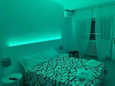 a bedroom with three beds and a hallway with a table at Dolce Vita Rooms Monteverde Trastevere in Rome