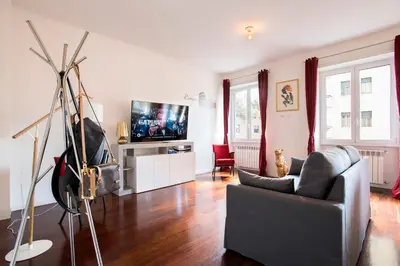 a living room with a couch and a tv at Piramide Family Apartment Rome in Rome