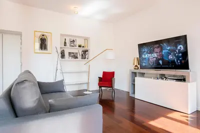 a living room with a couch and a flat screen tv at Piramide Family Apartment Rome in Rome