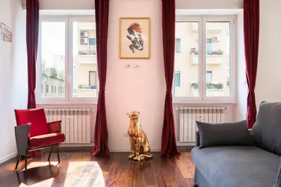 a living room with a dog statue in the corner at Piramide Family Apartment Rome in Rome