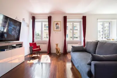 a living room with a couch and a tv at Piramide Family Apartment Rome in Rome