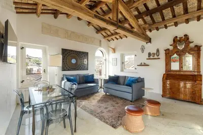 a living room with a blue couch and a table at Casa Adriana, a Burghesius home in Rome