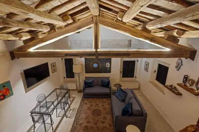 an overhead view of a living room with wooden ceilings at Casa Adriana, a Burghesius home in Rome