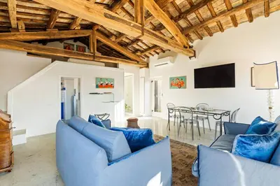 a living room with blue couches and a table at Casa Adriana, a Burghesius home in Rome