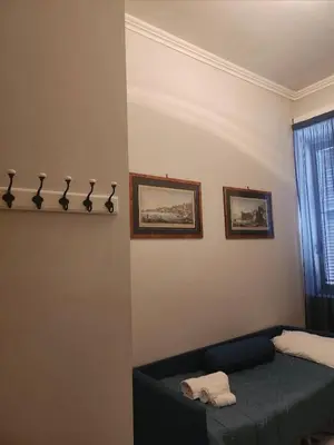 a bedroom with a bed and two pictures on the wall at Vatican Stairs Apartment in Rome