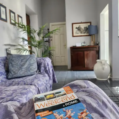 a living room with a couch and a magazine at Vatican Stairs Apartment in Rome