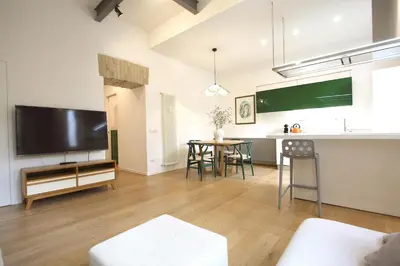 a living room with a large television and a table at Magnolia House in Testaccio in Rome