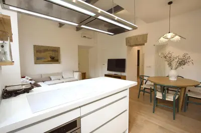 a kitchen and living room with a couch and a table at Magnolia House in Testaccio in Rome