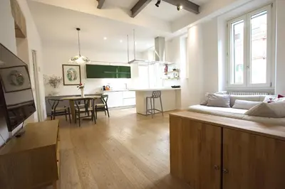 a living room and kitchen with a couch and a table at Magnolia House in Testaccio in Rome