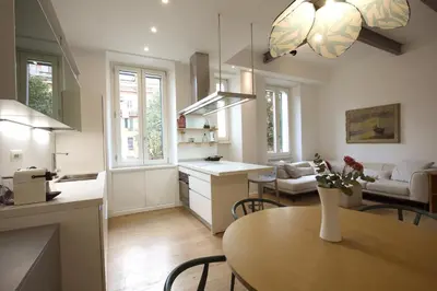 a kitchen and living room with a table in a room at Magnolia House in Testaccio in Rome