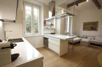 a kitchen and living room with a white counter top at Magnolia House in Testaccio in Rome