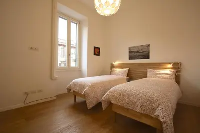 a bedroom with two beds and a window at Magnolia House in Testaccio in Rome