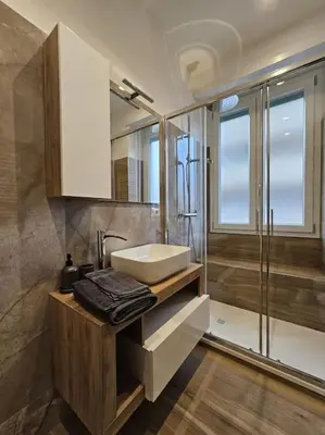 a bathroom with a sink and a shower at Re di Roma apartment in Rome