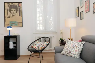 a living room with a chair and a couch at YCH-Brand new Vatican flat with terrace in Rome