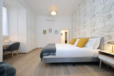 a bedroom with a large white bed with yellow pillows at YCH-Brand new Vatican flat with terrace in Rome