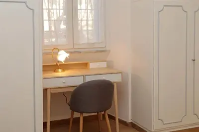 a desk with a chair and a lamp in a room at YCH-Brand new Vatican flat with terrace in Rome