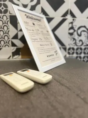 two remote controls sitting next to a menu on a counter at Casa Bravetta - Parking Private in Rome