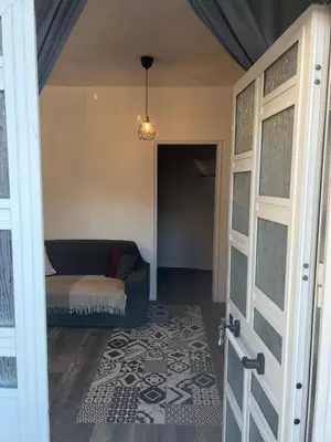 a living room with a couch and a door at Casa Bravetta - Parking Private in Rome