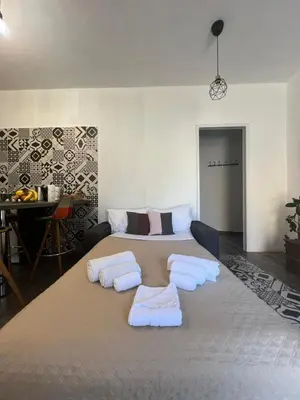 a bedroom with a large bed with towels on it at Casa Bravetta - Parking Private in Rome