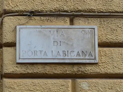 a sign on the side of a brick wall at Between Termini & Colosseo in Rome
