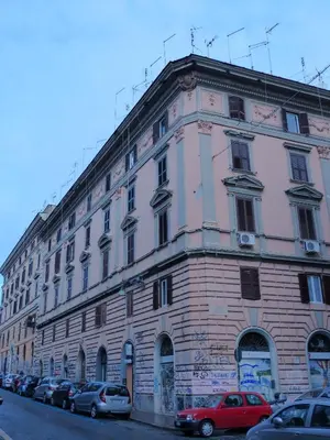 a large building with cars parked in front of it at Between Termini & Colosseo in Rome