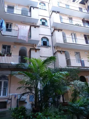 an apartment building with a towel hanging on a clothes line at Between Termini & Colosseo in Rome