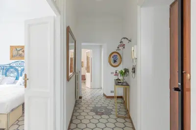 a bedroom with a bed and a hallway with a floor at iFlat Barberini 's Dream in Rome