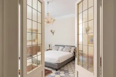 a bedroom with a bed and a chandelier at iFlat Barberini 's Dream in Rome