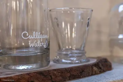 two clear glass vases sitting on a wooden table at Trevi Steps in Rome