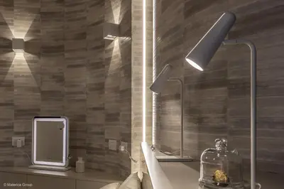 a bathroom with a sink and two lights on the wall at Trevi Steps in Rome