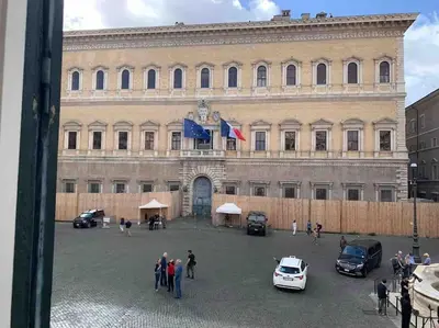 a large building with cars parked in front of it at Casa Cristina in Piazza Farnese in Rome