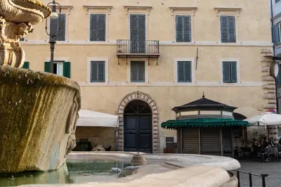 a fountain in front of a building at Casa Cristina in Piazza Farnese in Rome